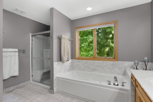 updated bath with tile floors and surround. Walk in shower and double vanity as well.