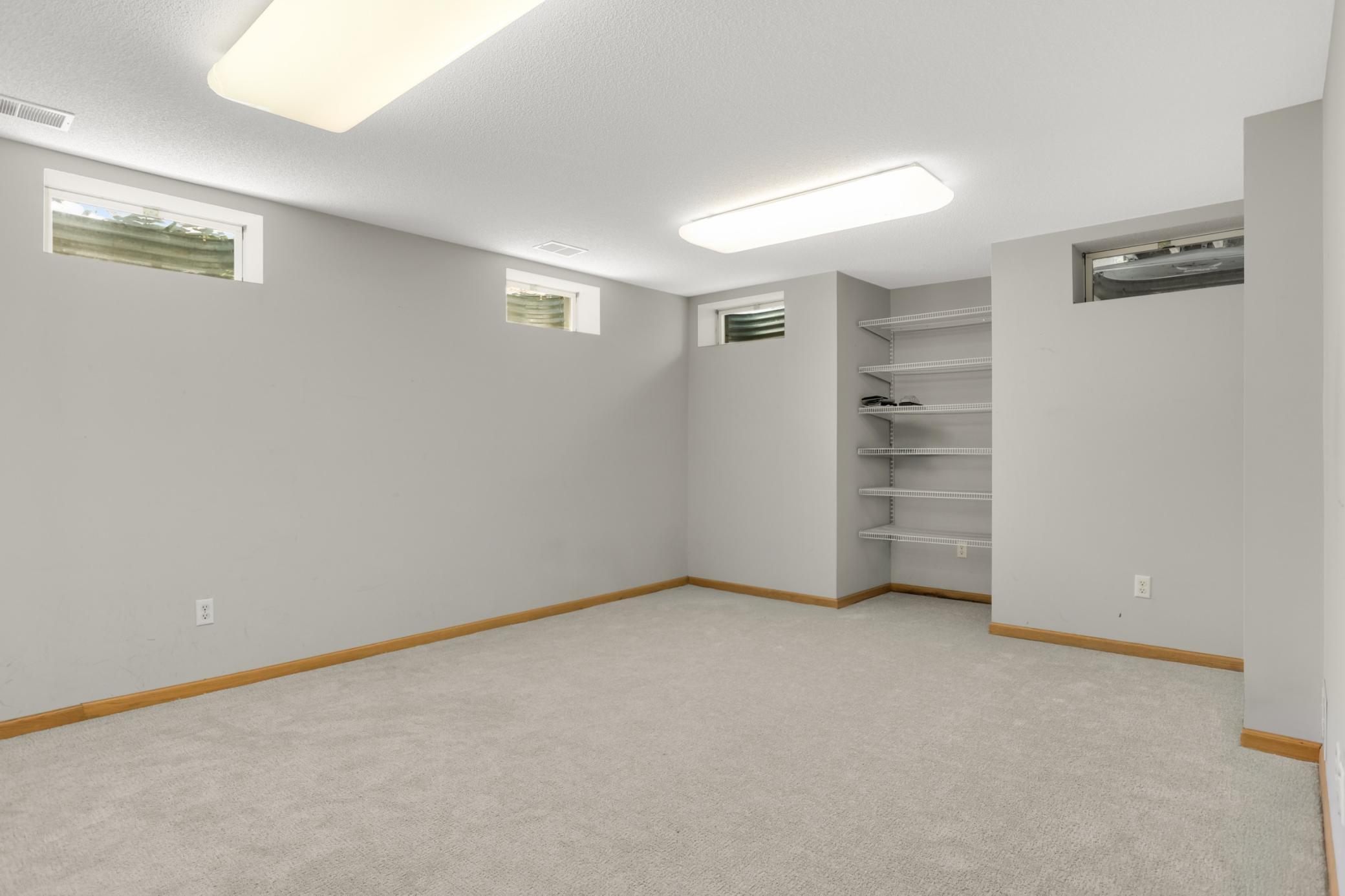 New carpet in this bonus room that was used as an office. Adding an egress window makes this bedroom #5. How would you use this space?