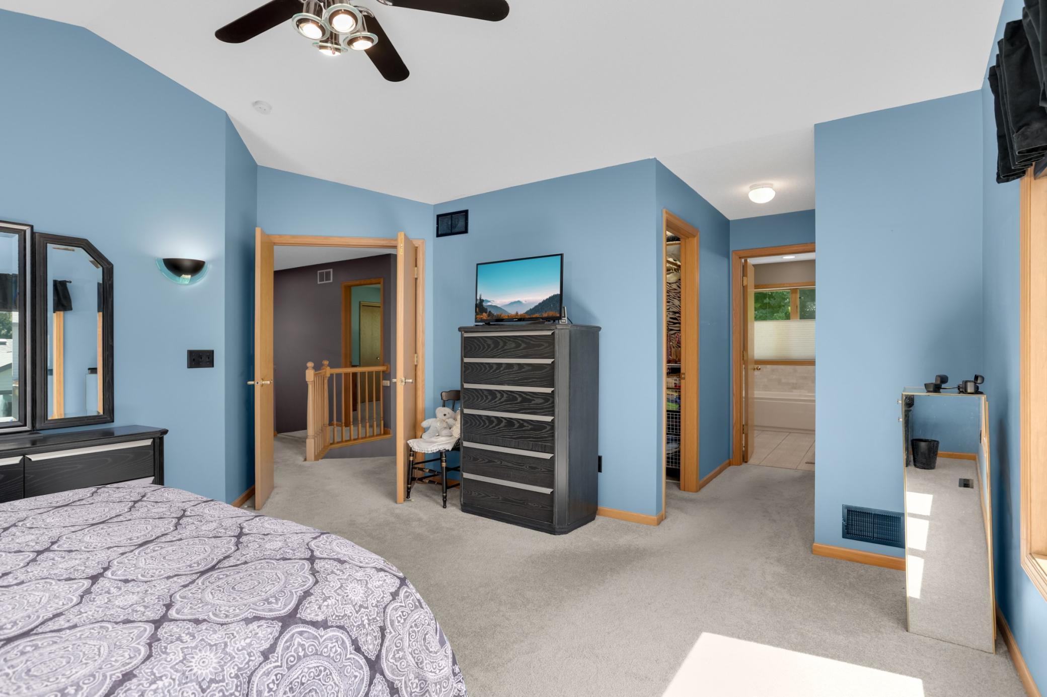 Double doors lead to a generously sized primary with vaulted ceiling, two closets (one is a walk in) and a private updated bath.