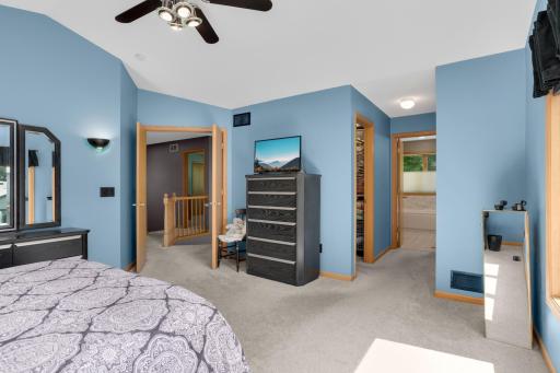 Double doors lead to a generously sized primary with vaulted ceiling, two closets (one is a walk in) and a private updated bath.