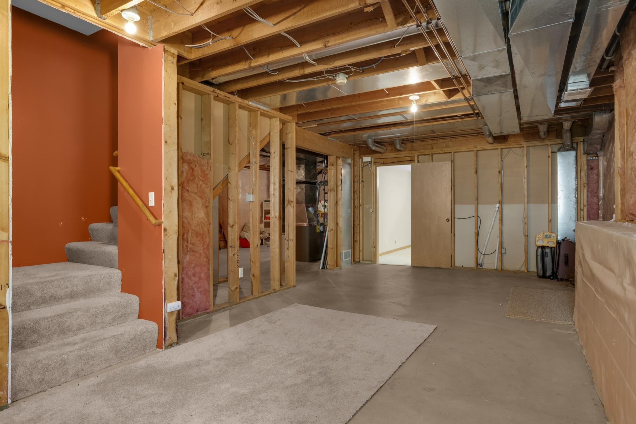 More storage space, mechanicals and a 4th bath rough in to the left. Doorway leads to the finished office space.