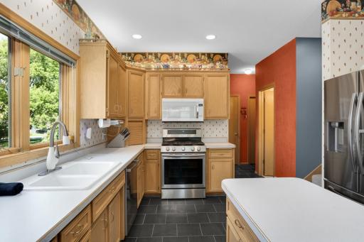 Next to the fridge is a sneak peak at the second hidden staircase to the upper level. What an uncommon convenience! Down the back hall find a convenient half bath, laundry room, and garage entrance.