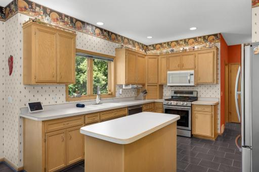 Newer appliances and plenty of counter space with a window looking over the backyard.