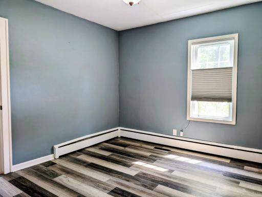 Main floor bedroom with new flooring and paint