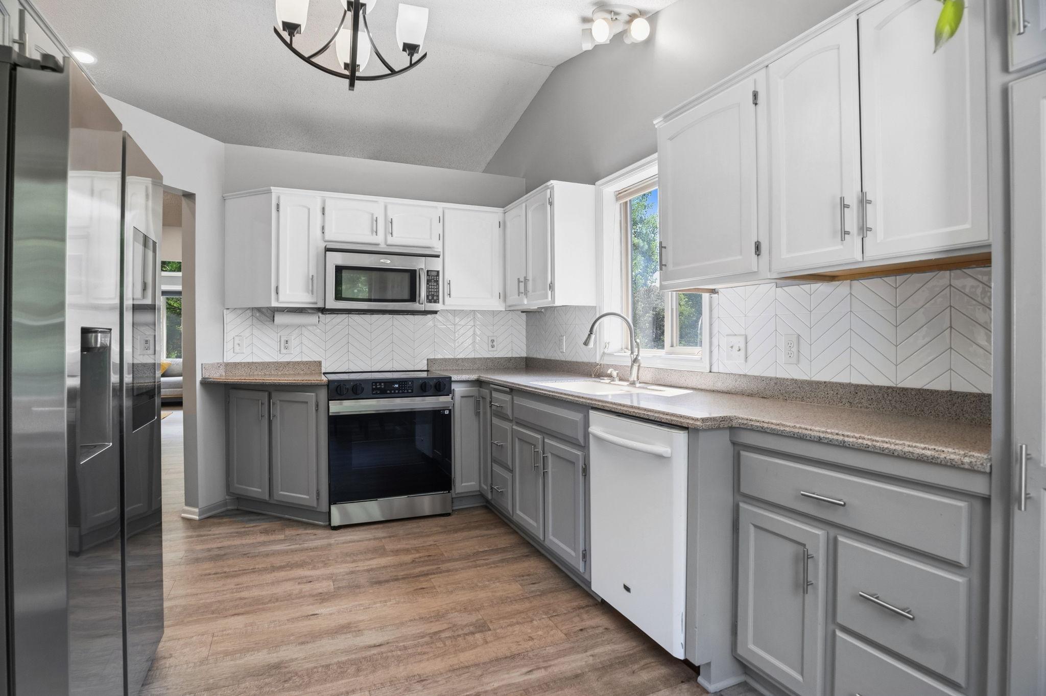 The spacious kitchen offers abundant cabinetry, updated appliances, and a functional layout for everyday cooking.