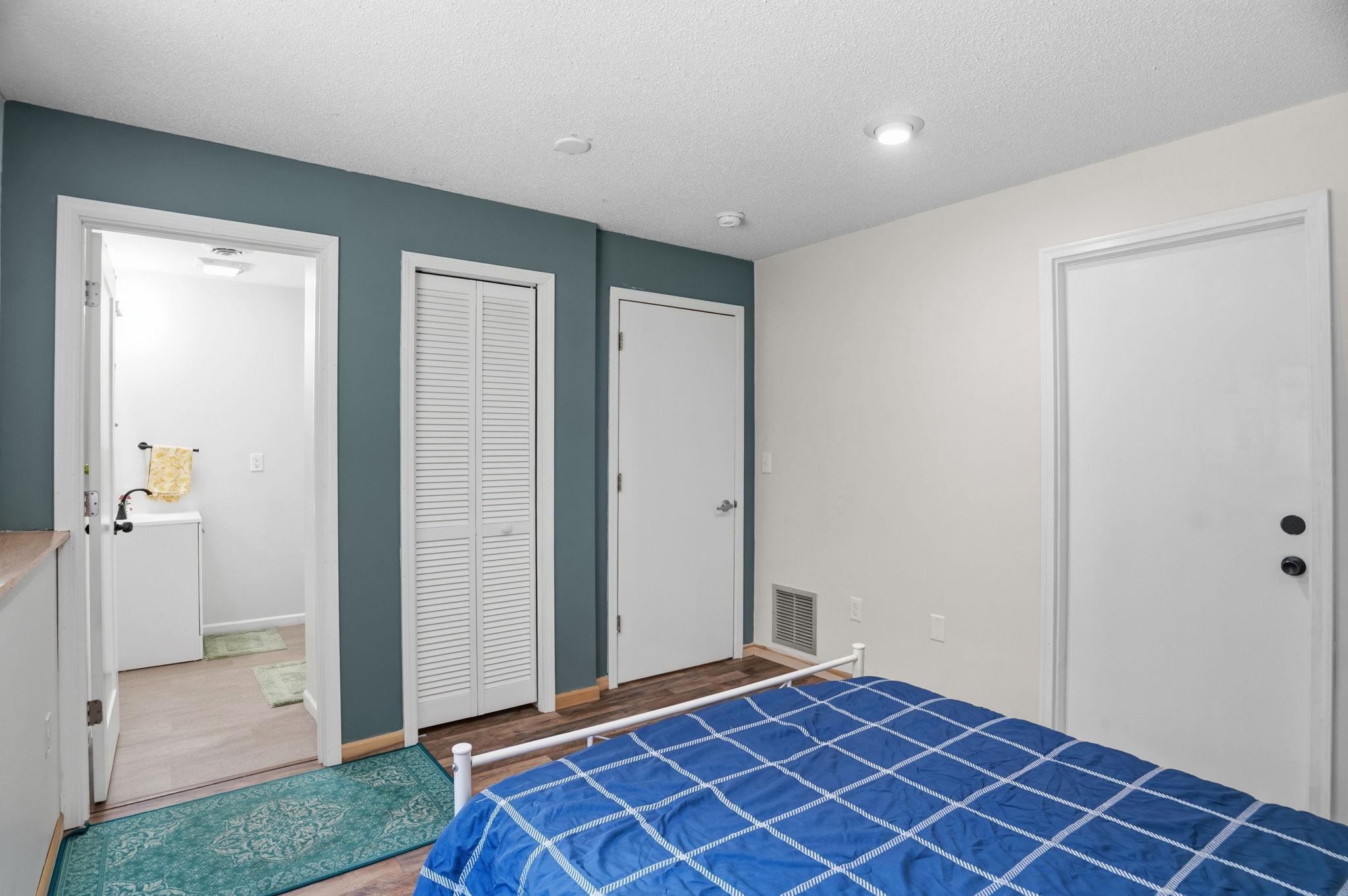 The lower-level ensuite offers a private bathroom, closet space, and a flexible layout ideal for guests or extended stays.