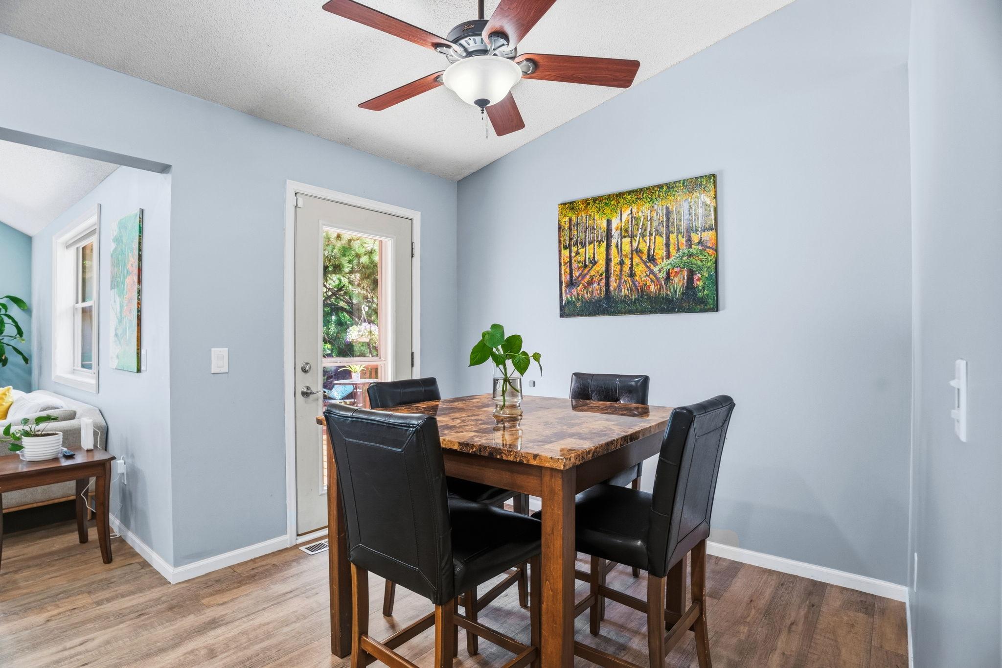 A bright dining area with direct deck access, perfect for meals, conversation, and entertaining.