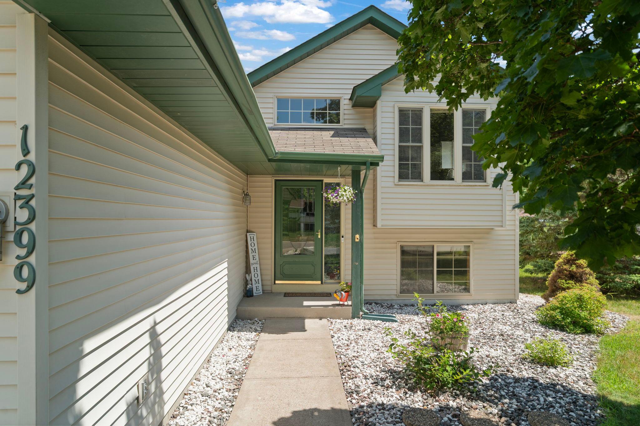 A charming covered entrance and low-maintenance landscaping create a warm welcome home.