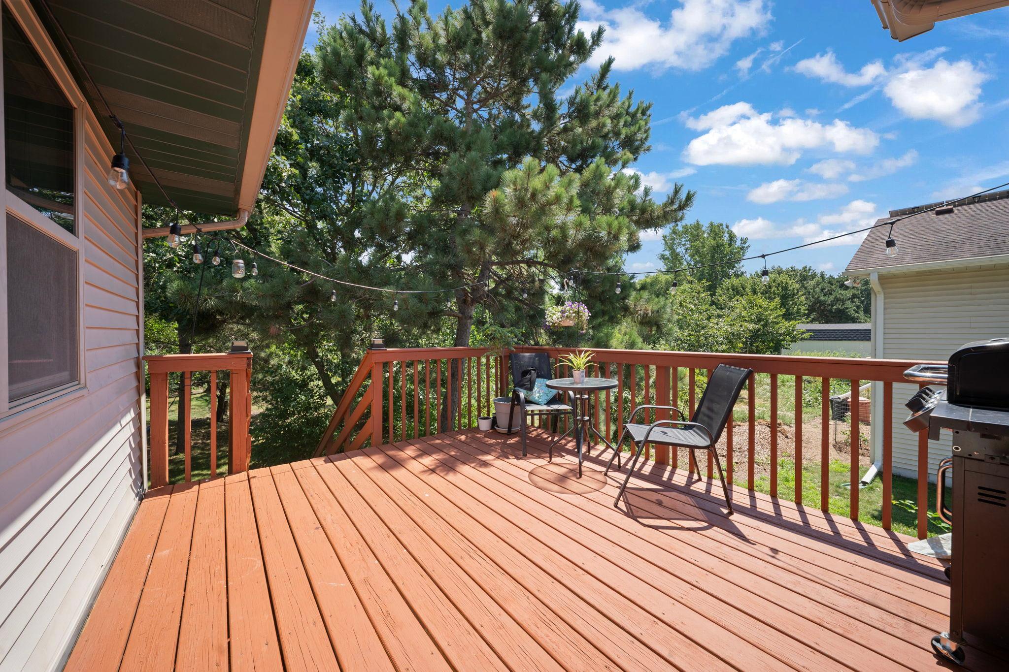 Enjoy peaceful treetop views from the elevated deck, an inviting setting for morning coffee or evening gatherings.