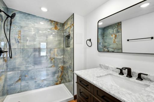 The spacious primary suite offers the comfort and privacy of its own beautifully finished en-suite bathroom with a walk-in shower, creating a functional retreat to begin and end your day.