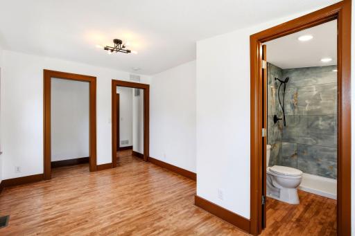 The spacious primary suite offers the comfort and privacy of its own beautifully finished en-suite bathroom with a walk-in shower, creating a functional retreat to begin and end your day.