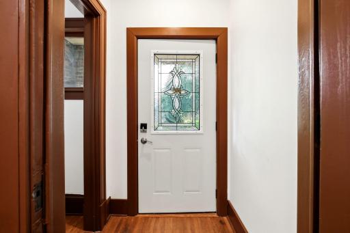 Step through the beautiful stained-glass front door into a spacious entryway that fills the home with warmth, character, and an inviting first impression.