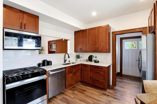 Every detail of this kitchen has been thoughtfully updated, including new wood cabinetry, elegant countertops, a full suite of brand-new stainless steel appliances, and modern fixtures, creating a beautiful and highly functional space.