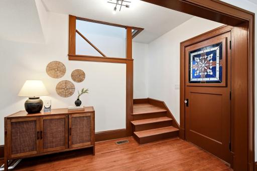 Step through the beautiful stained-glass front door into a spacious entryway that fills the home with warmth, character, and an inviting first impression.