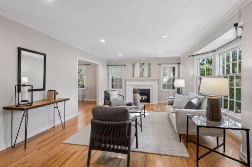 Cozy living room with newer gas fireplace & refinished hardwood floors.