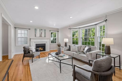 Cozy living room with newer gas fireplace & refinished hardwood floors.
