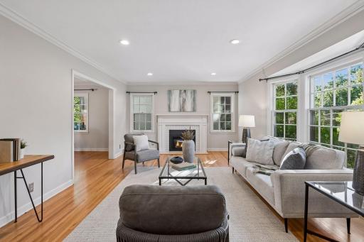 Cozy living room with newer gas fireplace & refinished hardwood floors.