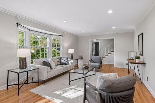Cozy living room with newer gas fireplace & refinished hardwood floors.
