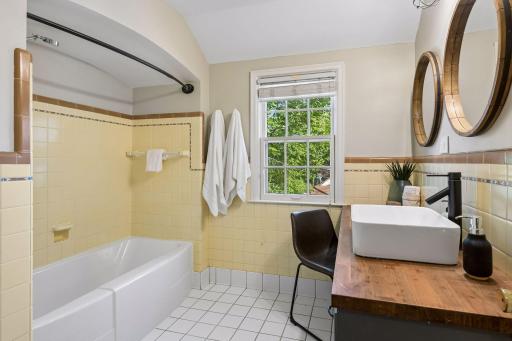 Upper level full bath with original tile.