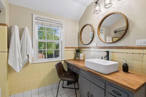 Upper level full bath with original tile.