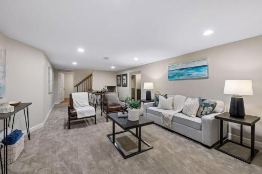 Beautifully remodeled basement features a wet bar, an additional full bathroom, a spacious family room, and another flexible space that works as an office, workout room, or nonconforming 5th bedroom.