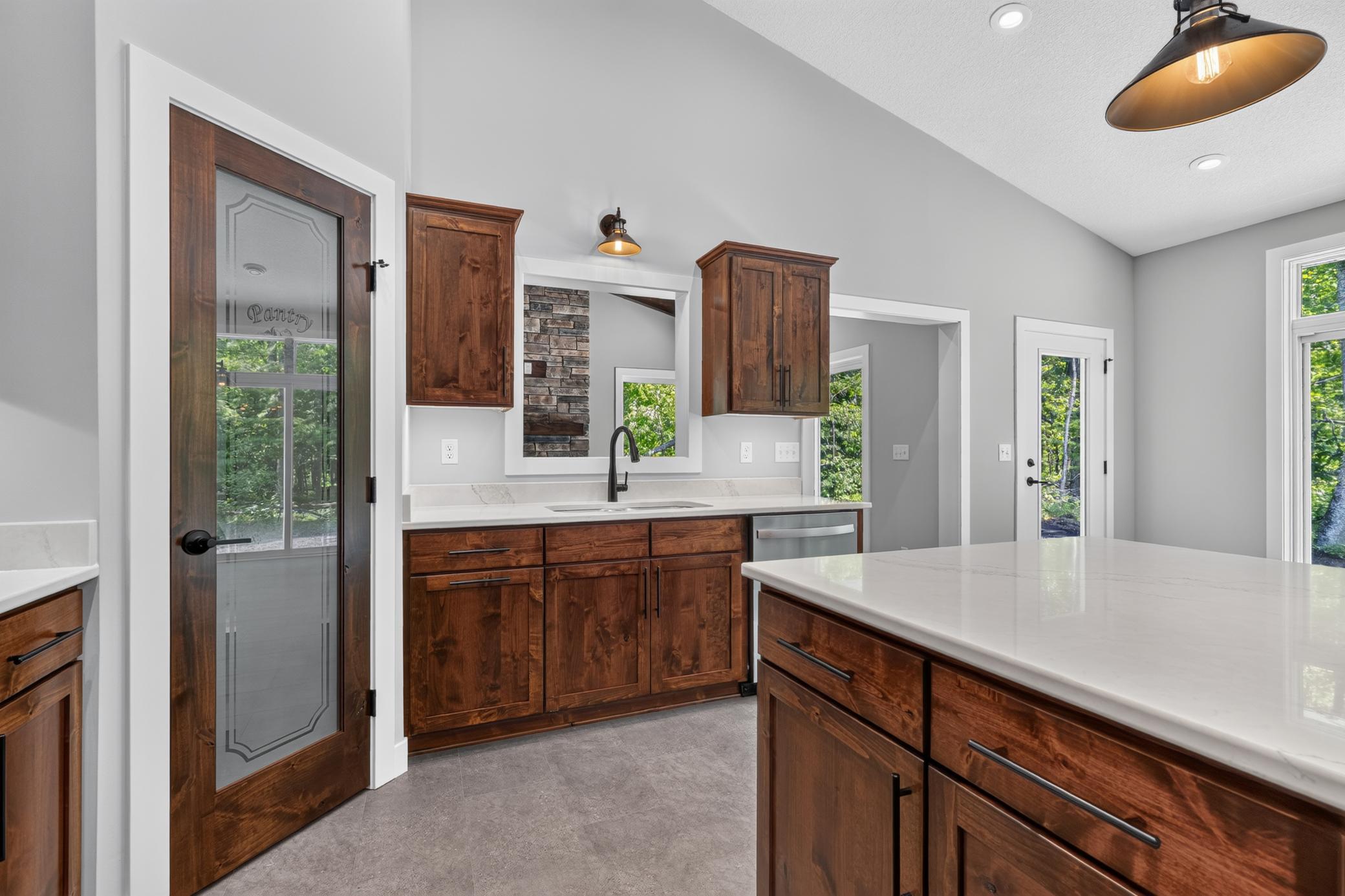 The kitchen also features LED under cabinet lighting throughout the kitchen, and a custom Knotty Alder pantry door