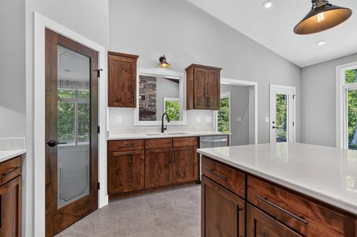 The kitchen also features LED under cabinet lighting throughout the kitchen, and a custom Knotty Alder pantry door