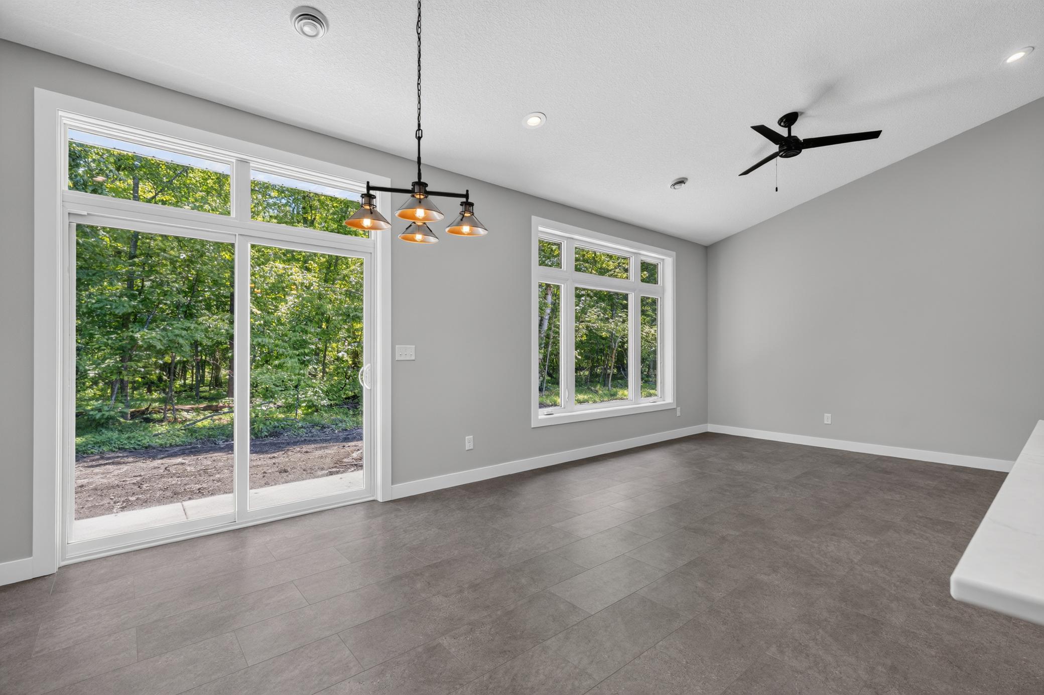 You will love the convenience of the sliding door from the dining and living area in the wooded back yard.