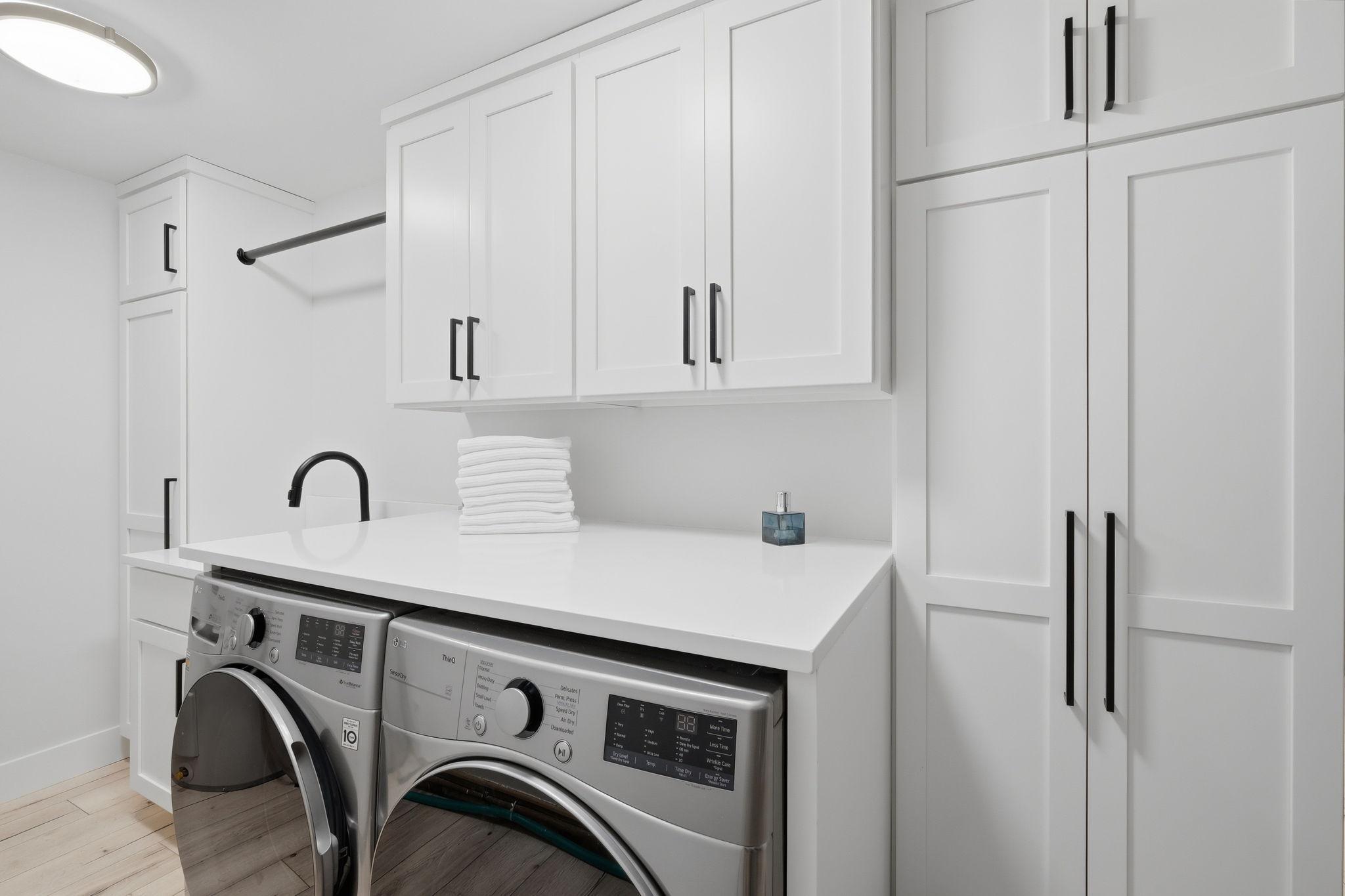 In unit laundry also features loads of custom cabinets