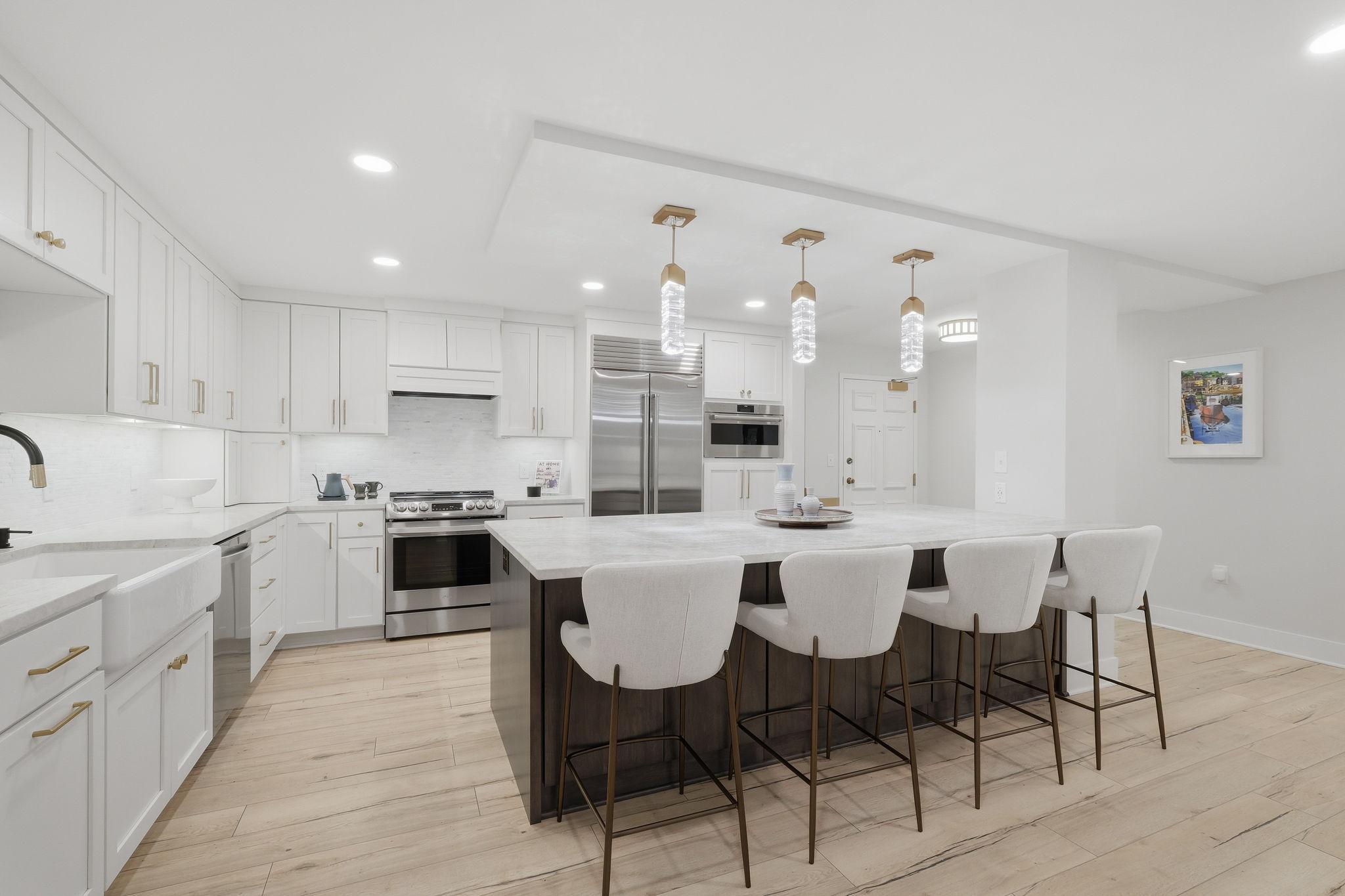 Features include a huge island with storage on both sides, Taj Mahal all natural quartzite countertops, Sub Zero refrigerator/freezer, Wolf steam oven, and more