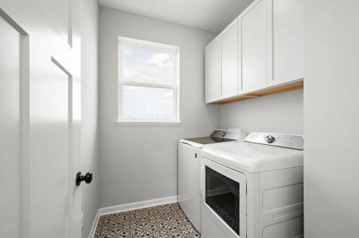 Upper Level Landry Room with newly installed cabinets by seller.