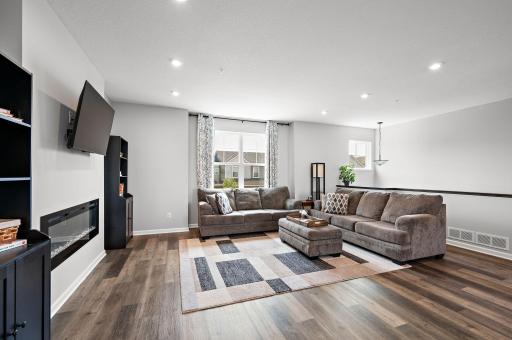 Large main floor family room with an electric fireplace and recessed LED lighting!