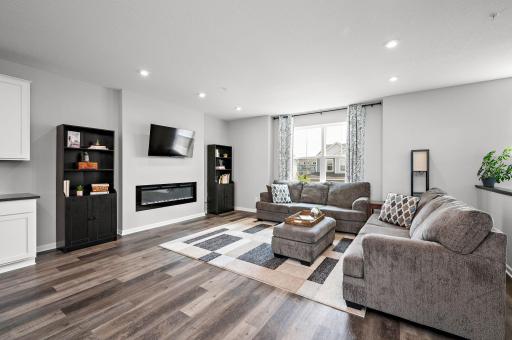 Large main floor family room with an electric fireplace and recessed LED lighting!