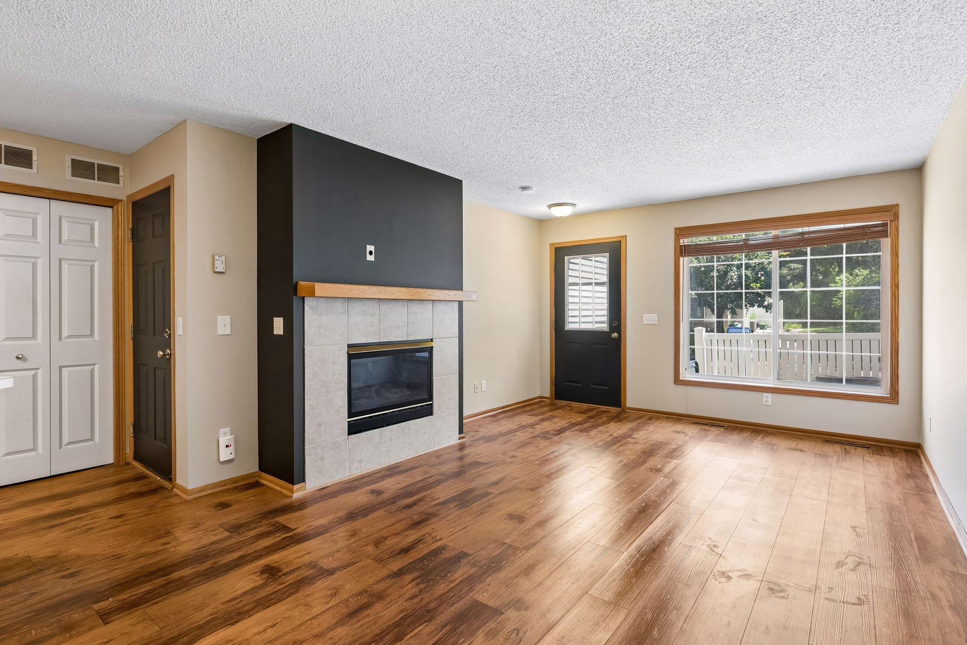 Freshly painted interior with sharp accent wall and gas fireplace.