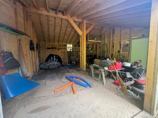A roomy two-car garage adds valuable convenience and functionality to this cabin property. The garage offers ample space for cars and water craft