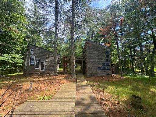 Wrapped in timeless cedar siding, the cabinâs exterior blends seamlessly into its wooded surroundings. The natural grain and warm tones of the cedar create an inviting, rustic charm while offering durability and weather resistance.