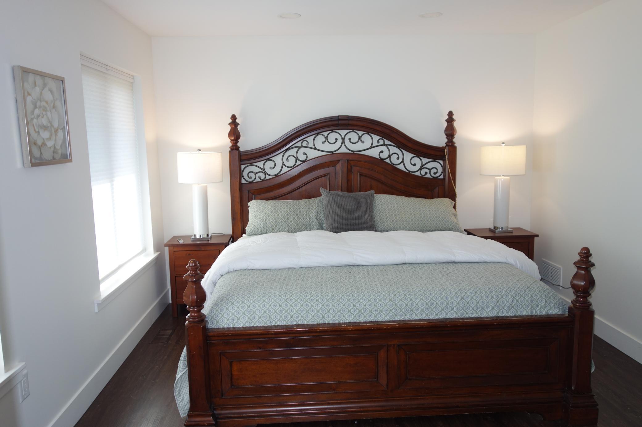 Large primary bedroom with two sets of windows to the back yard.