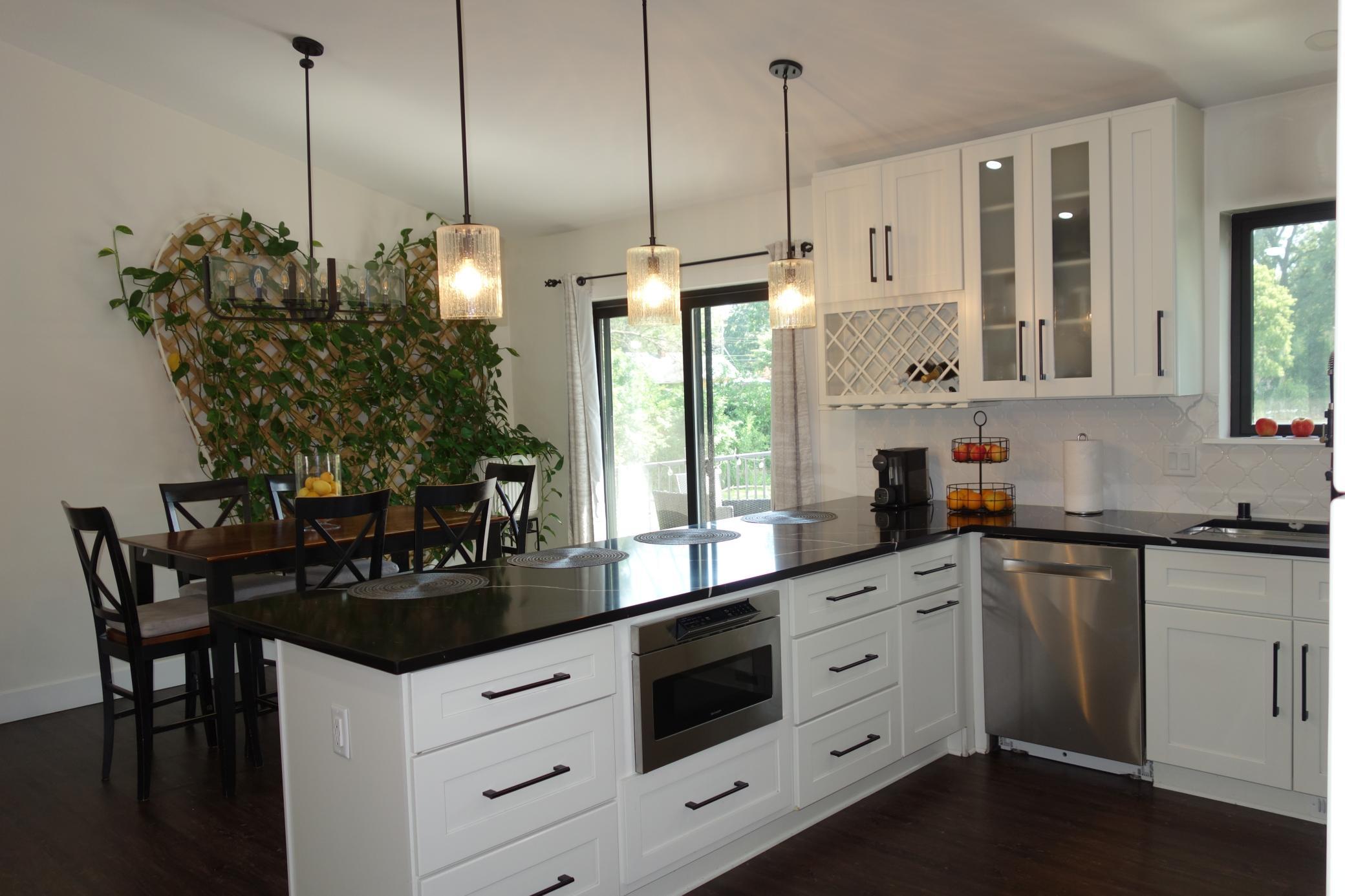 Quartz countertops, wine rack, in-counter microwave and beautiful back splash.