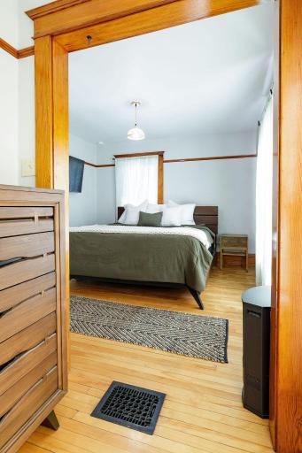 Look into the primary bedroom from the closet/dressing space