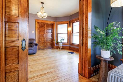 Living room has panel pocket doors to open the space or close off the rooms