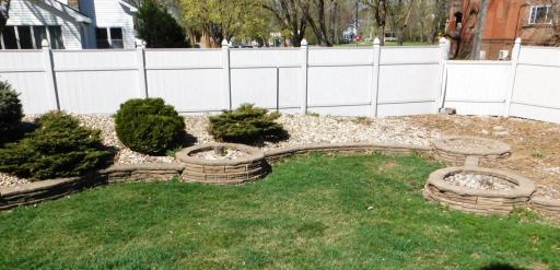 Big back yard with privacy fence and rock garden