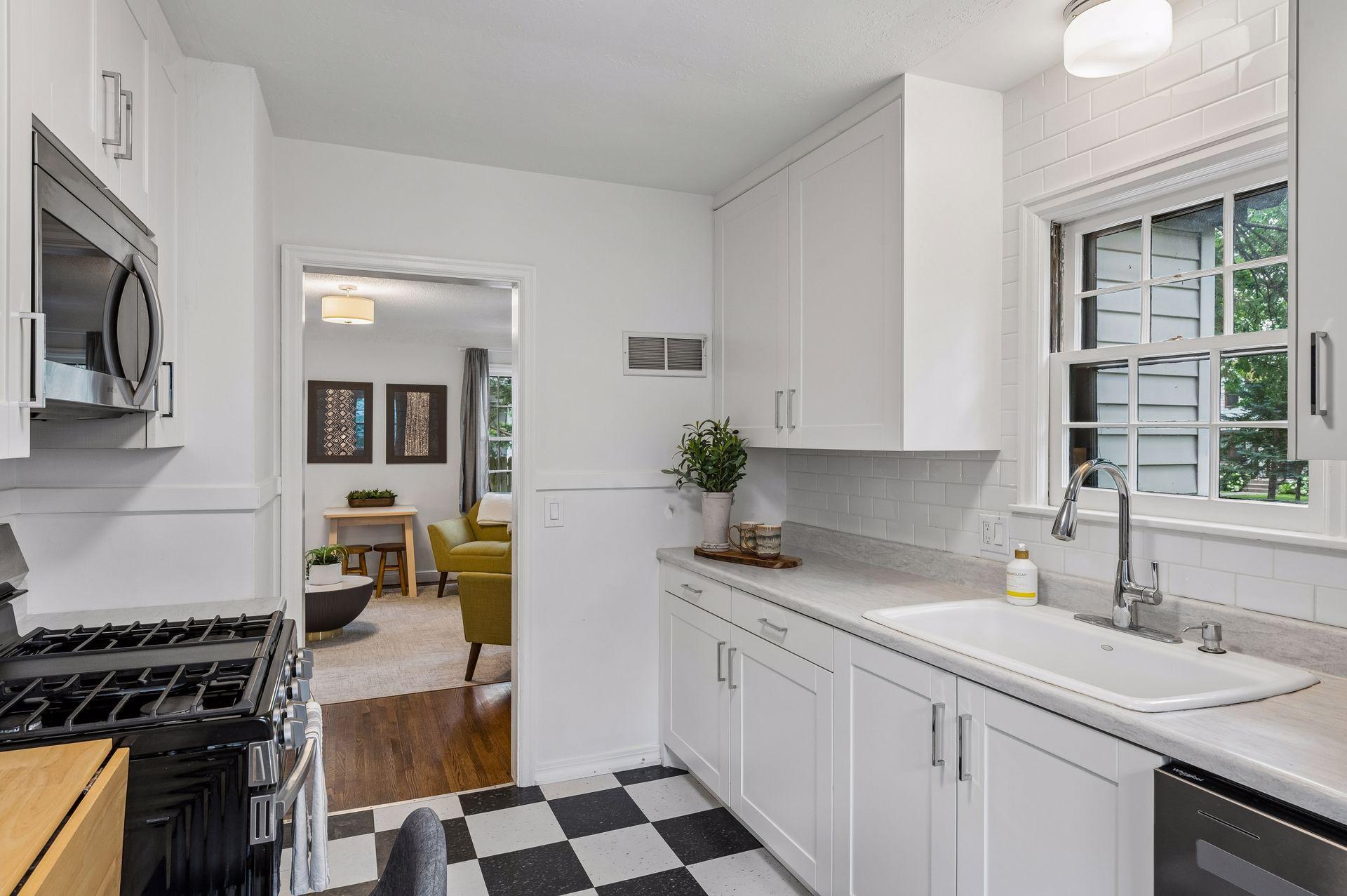 Large kitchen sink with window that looks out to the front yard.