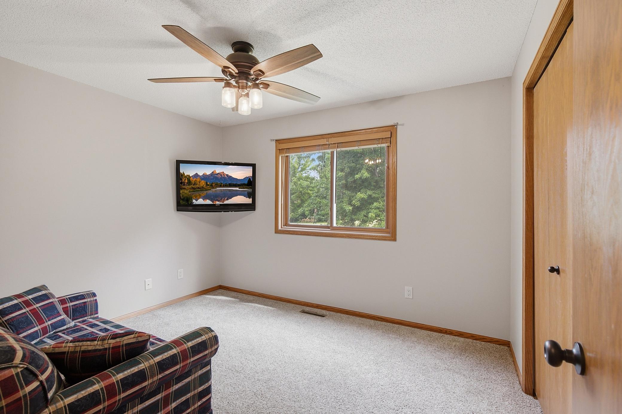 The third bedroom on the upper level is currently being used as a TV room/den.