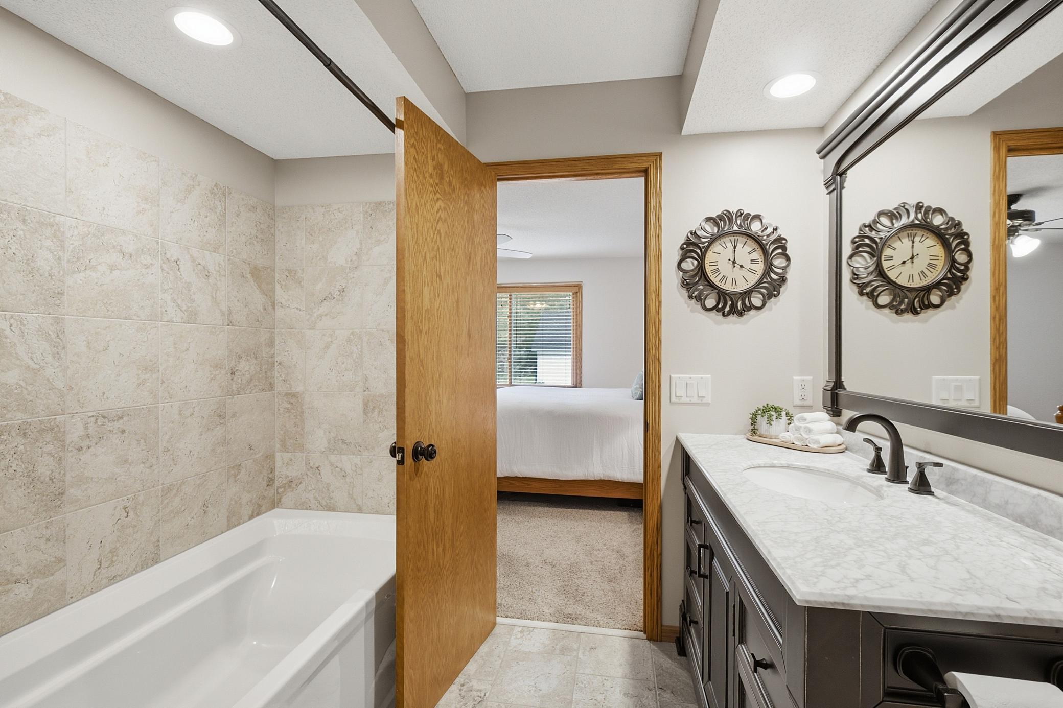 The 2026 bathroom remodel features a gorgeous tile surround, new vainity with granite top, new flooring and new fixtures and commode.
