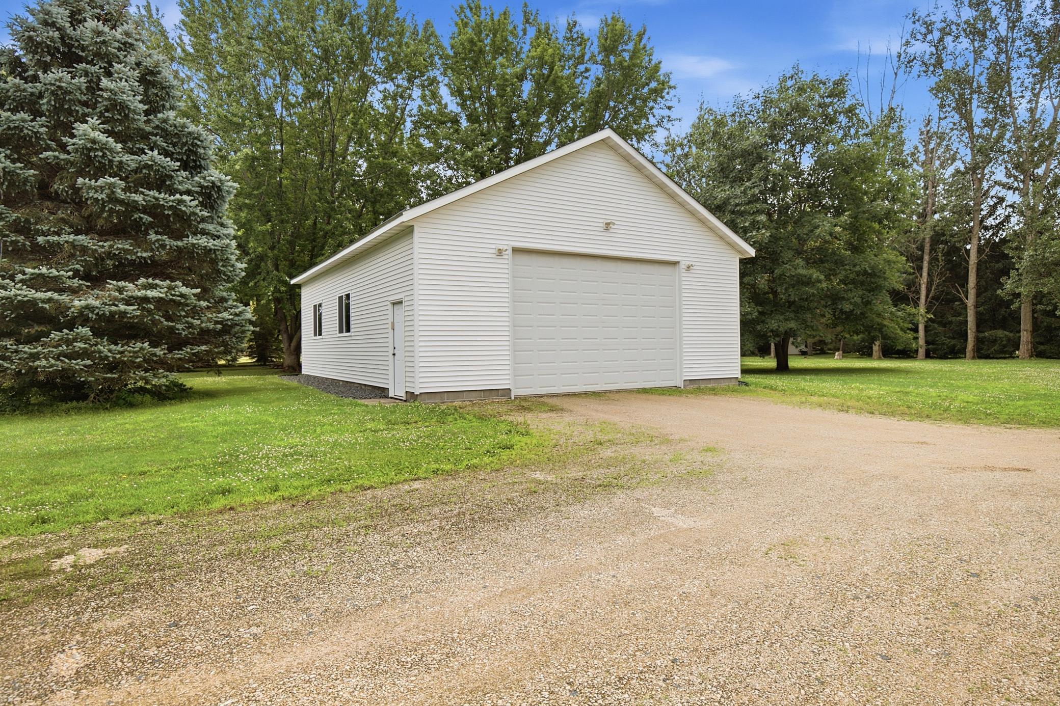 Impressive Detatched garage with power, storage attic, 12 ft walls, concrete floor, new roof and siding in 2024