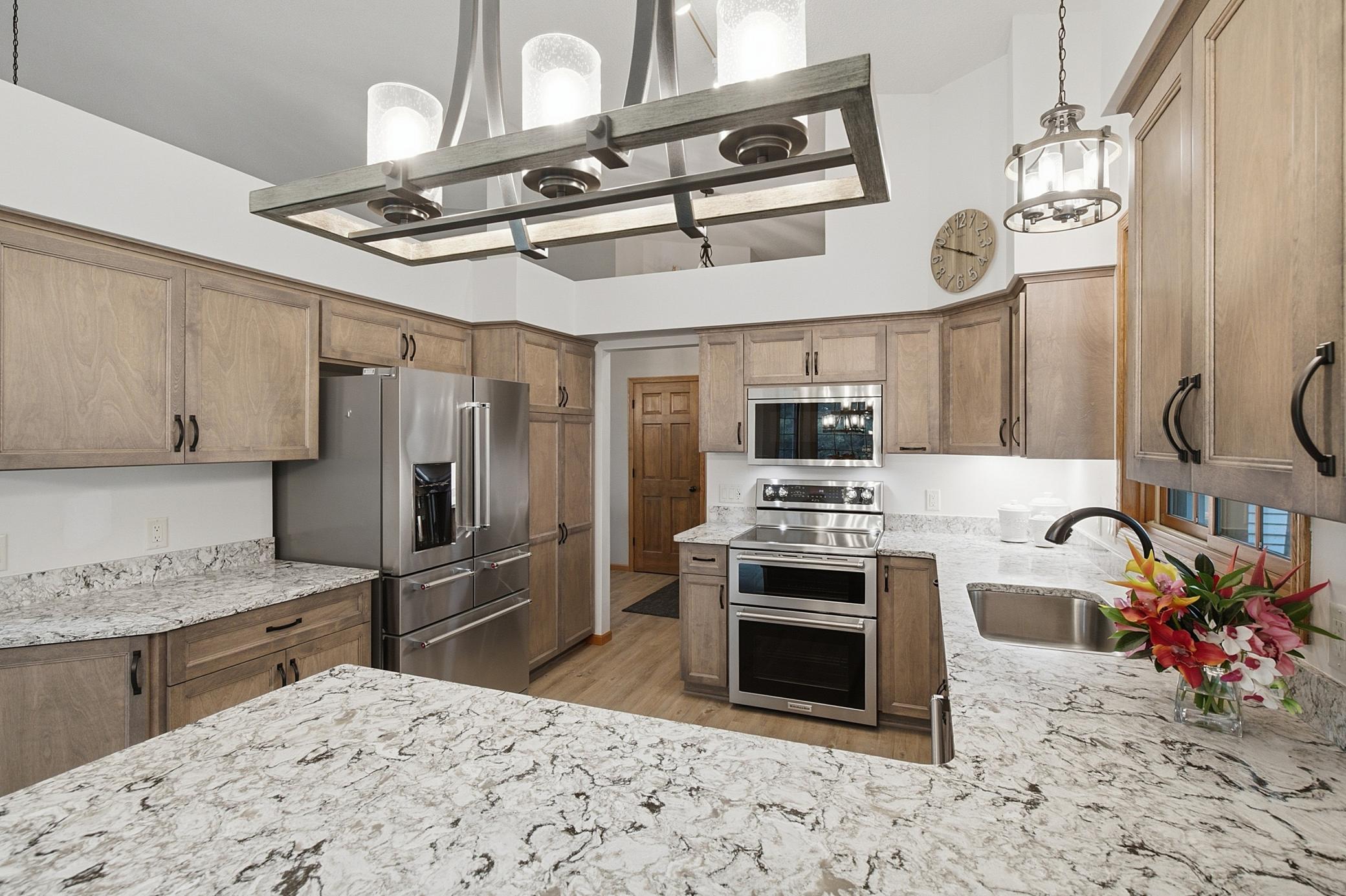 Updated appliances include a double oven feature and serving drawers in the fridge.