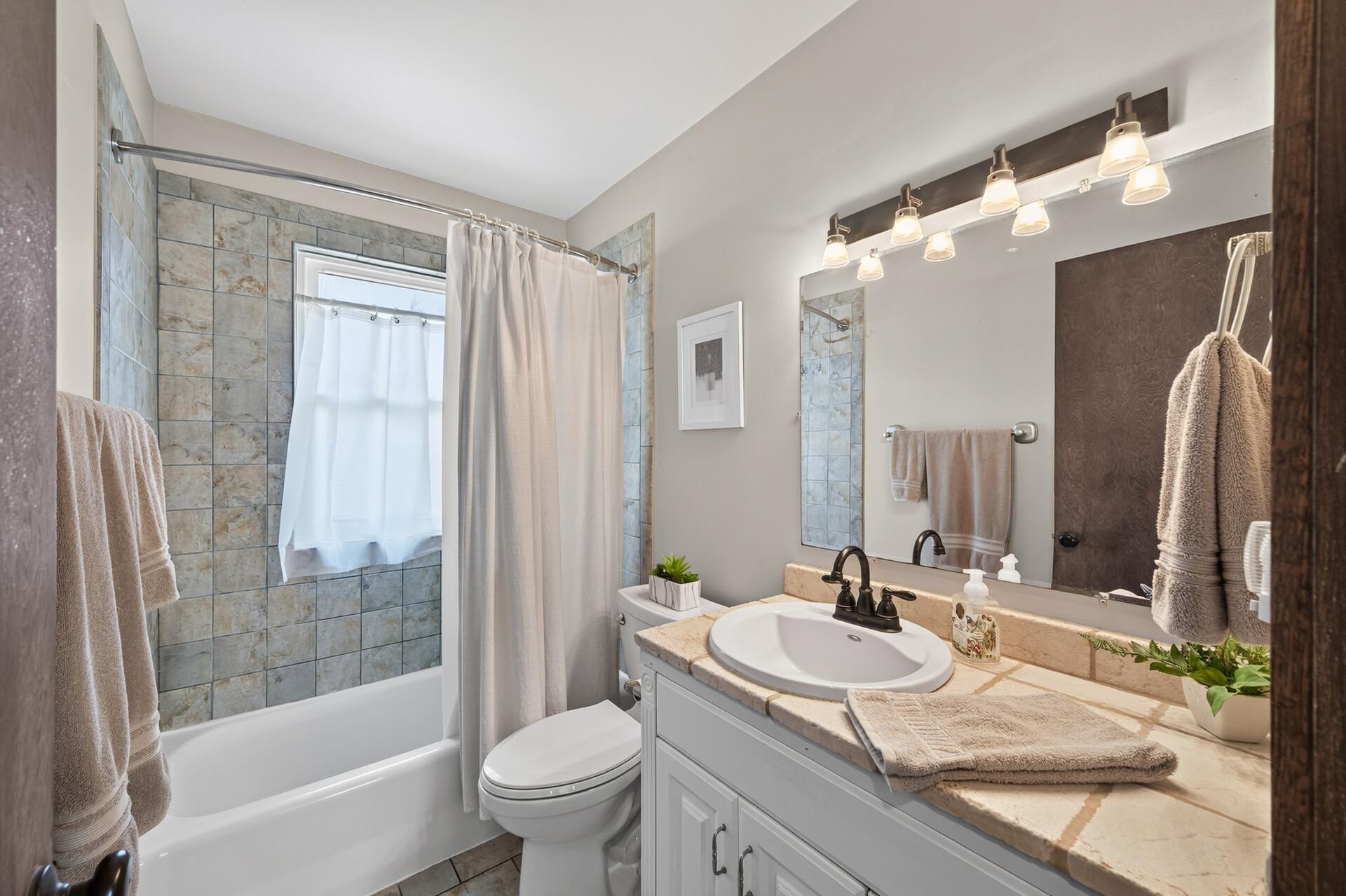 Tile, tile and more tile. Nicely finished full bathroom.