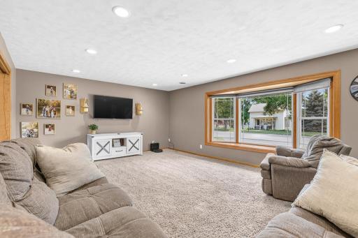 Spacious main level living room features large bay window, updated carpet, recessed lighting!