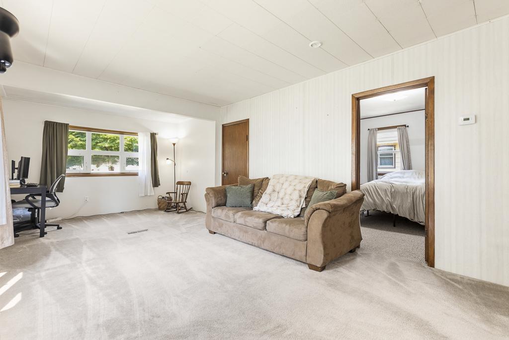 Just off of the living room is a main floor bedroom and access to the upper level