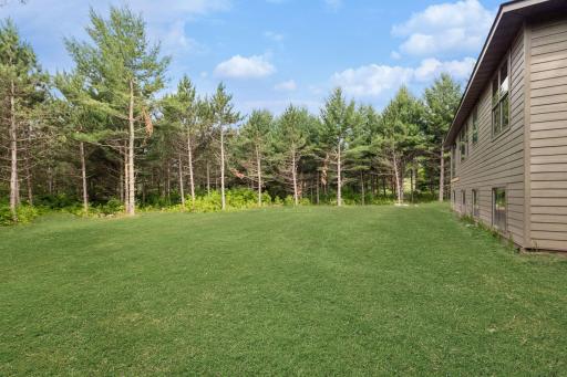Back of house; this photo has been digitally enhanced. The grass shown in this image is not present at the property and is for visualization purposes only.